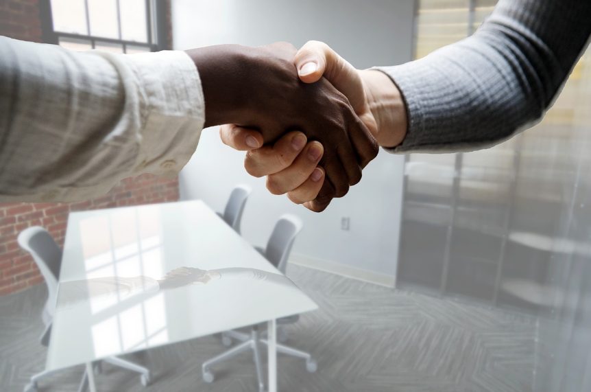 two people shaking hands at the office